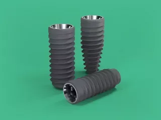 Three Straumann implants with a fine, matt grey surface.